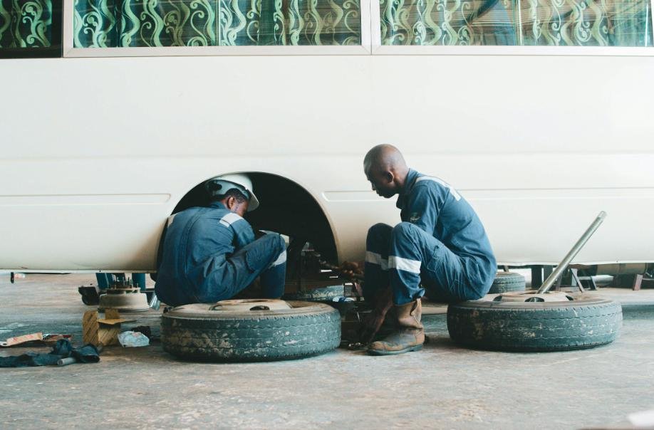 Professionals changing the tires of an RV.