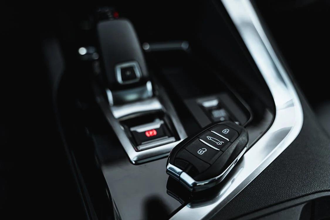 An image of a key fob remote placed inside a car