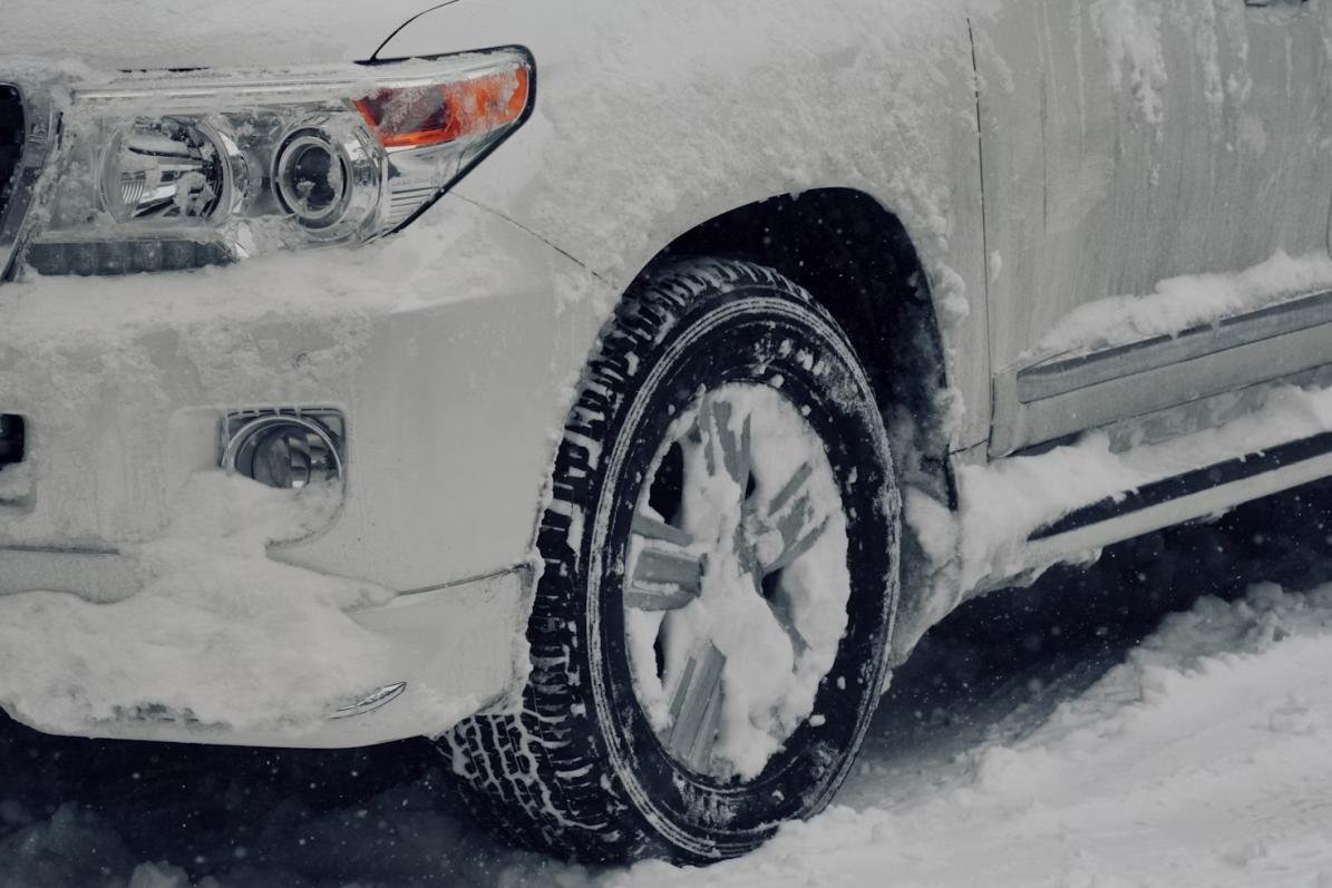 An image of a car tire covered in snow