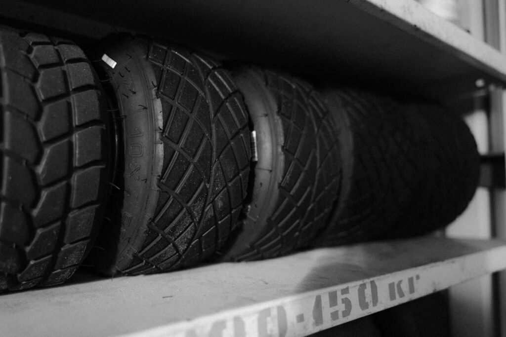 A row of spare tires neatly arranged on a storage shelf