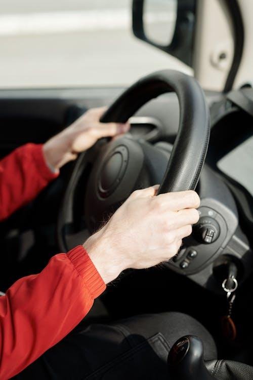 Person’s handling a steering wheel