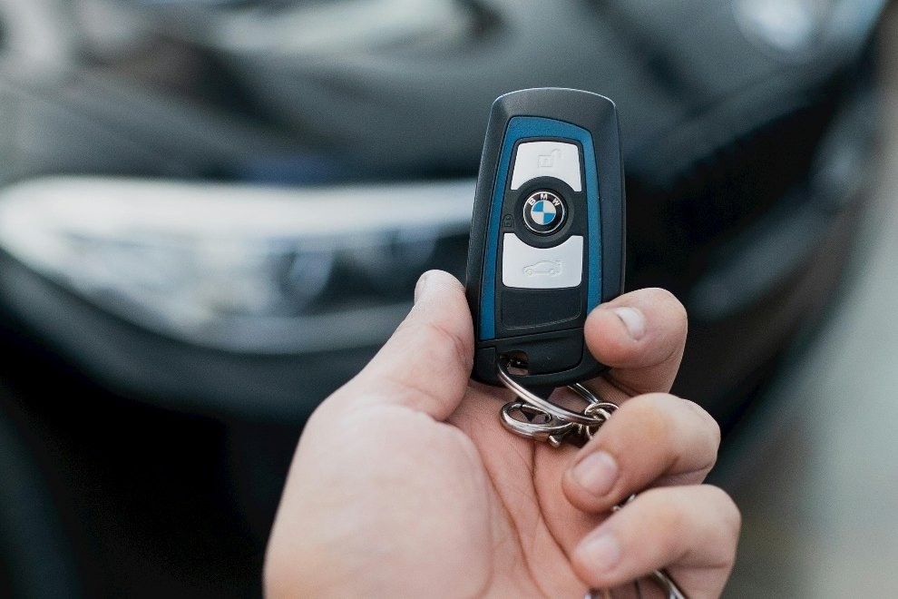 Person holding a key fob in their hand