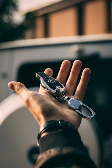 a person holding keys to a Mercedes